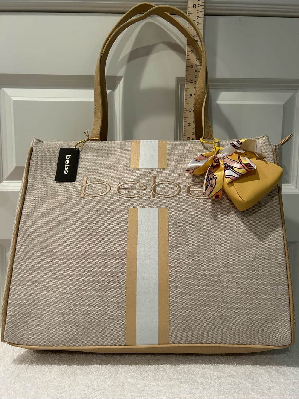 bebe Paisley Beige Canvas Tote with Mustard Accents and Scarf Charm